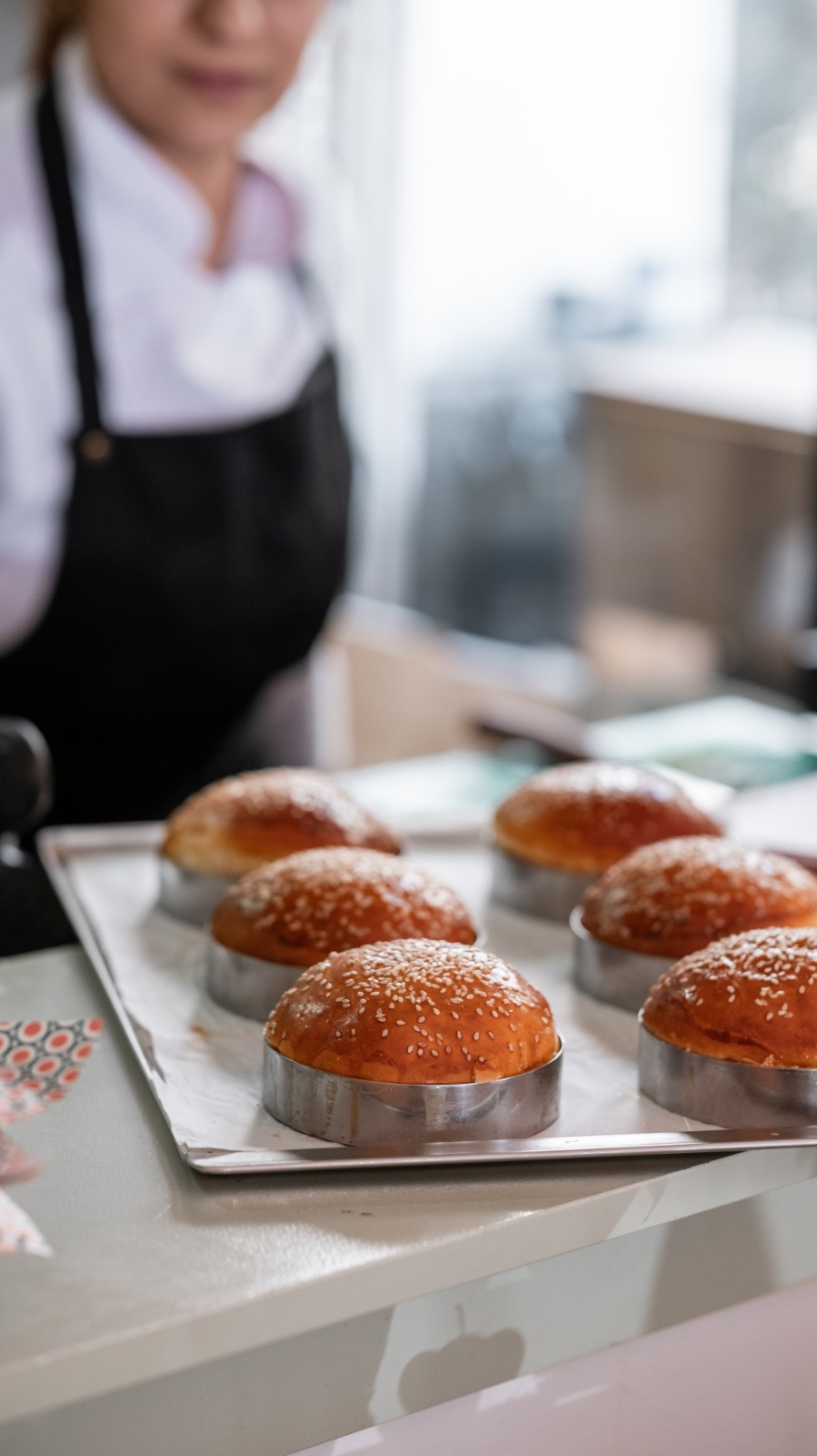 Miante mutfağında tepsi üzerinde yeni fırınlanmış burger ekmekleri